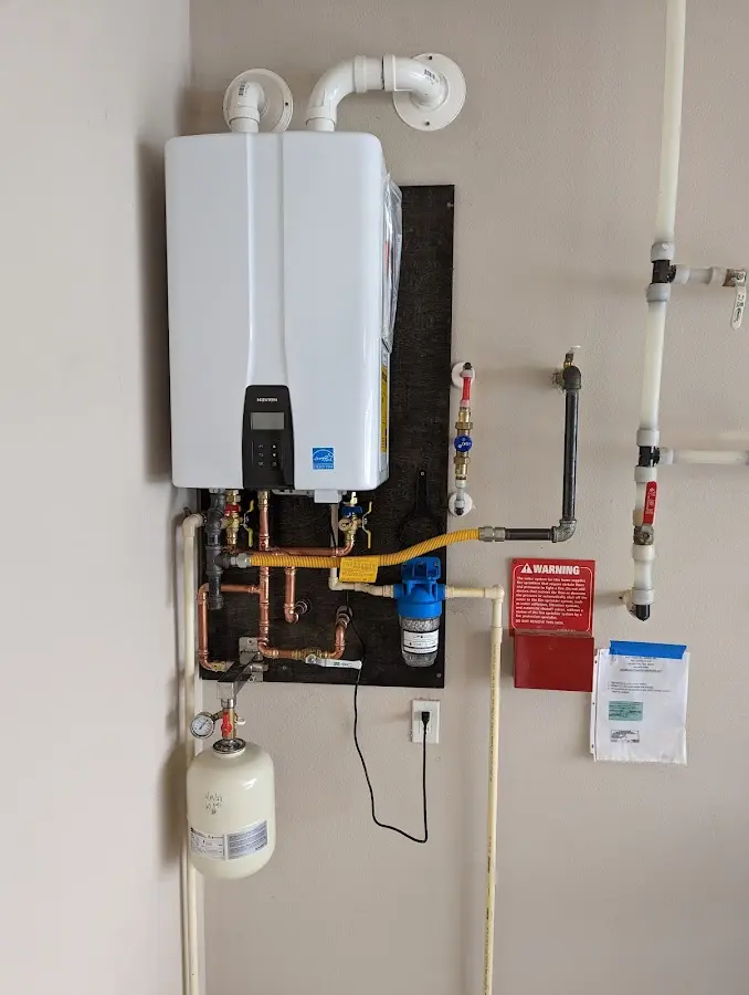 Professional plumber installing copper piping in a Summerfield home